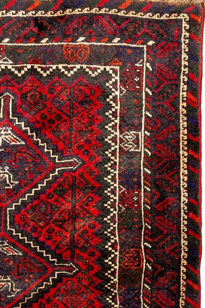 Image showcasing an intricate Fars province carpet with rich colors and traditional motifs.