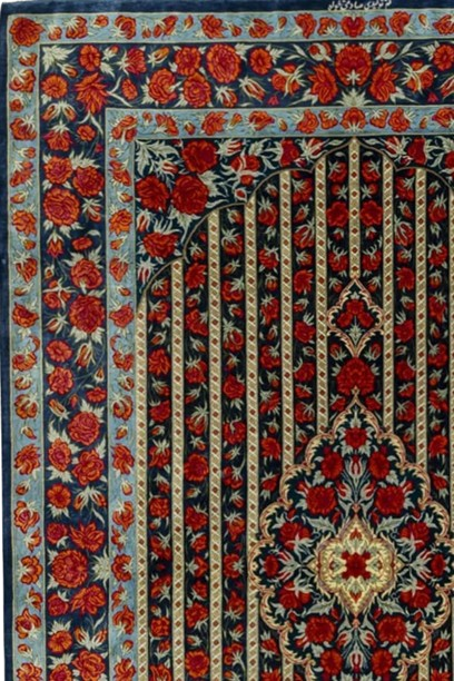 "Rose Symphony" hand-knotted silk rug with a midnight blue background, vibrant red roses, and a sky blue border with continuous rose motif, crafted in Qom, Iran.