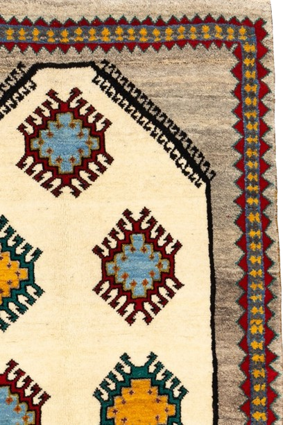 Image showing a handwoven Gabbeh rug with geometric patterns and earthy hues.