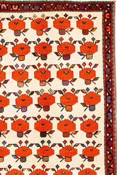 Image of a floral pattern carpet with a rich red background and intricate design.