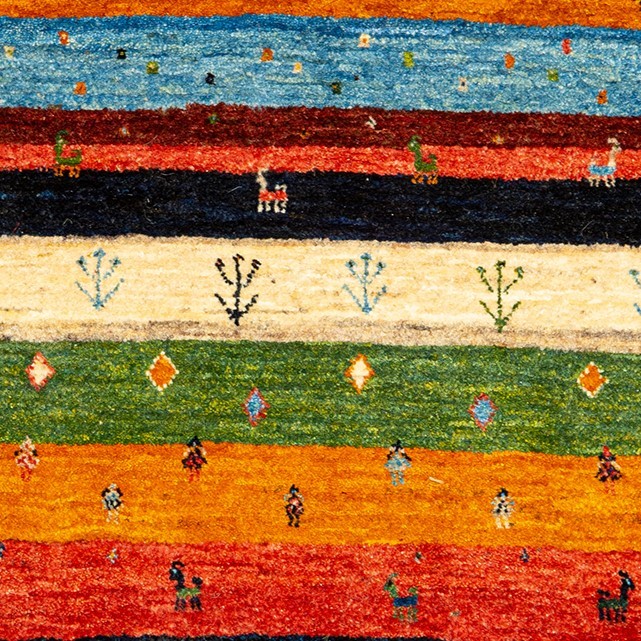 Image of the Rainbow Harmony Gabbeh rug showcasing vibrant stripes and intricate plant and animal motifs.