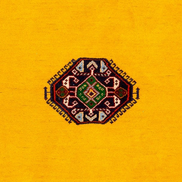 Image of a precision-crafted rug with a bold yellow center and elaborate borders.