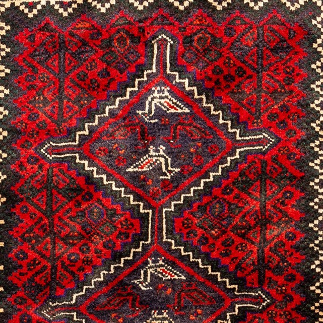 Image showcasing an intricate Fars province carpet with rich colors and traditional motifs.